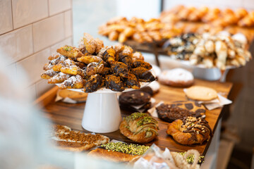 Fresh sweet pastries displayed on counter of bakery cafe