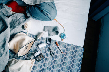 Sewing supplies and fabric on a bed