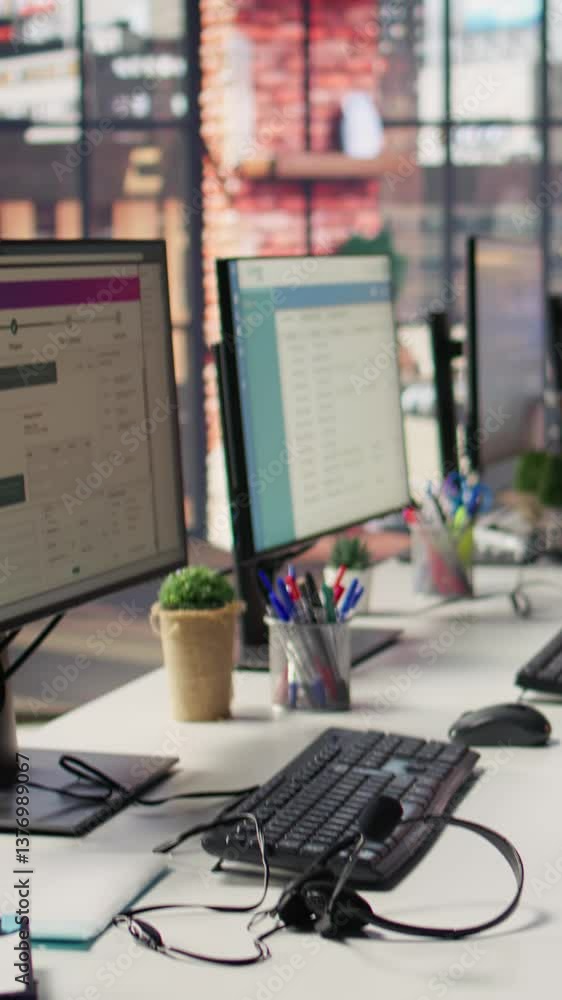 Poster vertical video csm system interfaces on computer monitors in empty customer service workplace and ca