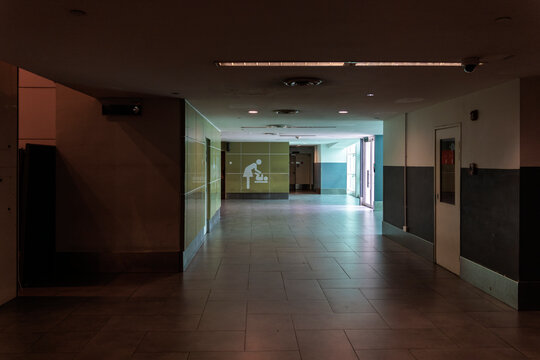 Interior of empty airport terminal with doors and signs