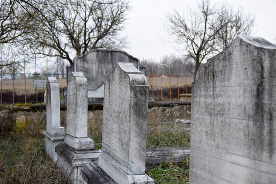 Old Tombstones in a Quiet Rural Cemetery on an Overcast Day