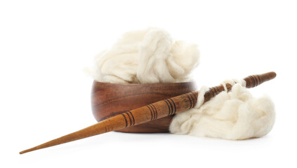 Heap of clean wool with wooden spindle and bowl isolated on white