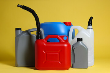 Many different plastic canisters on yellow background