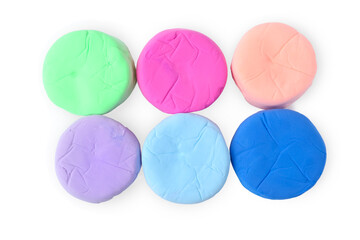 Different colorful play dough isolated on white, top view