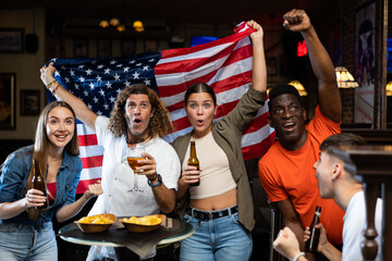 Smiling man and woman drinking alcohol and having conversation on party in nightclub