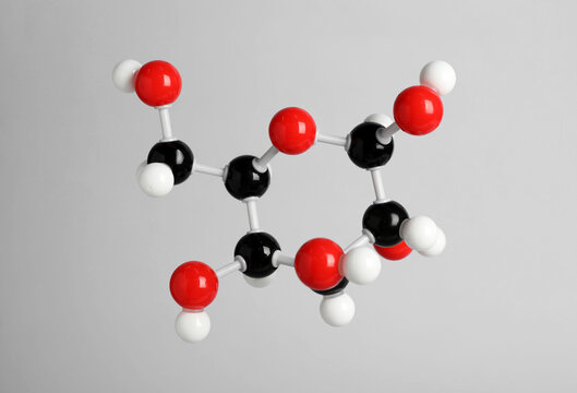 Molecule of glucose on light grey background. Chemical model