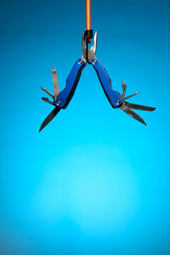Hanging Blue Multitool with Open Blades