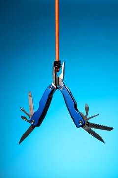 Suspended Blue Multitool with Open Blades