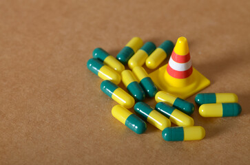 Medication Warnings: Capsules and Traffic Cone Symbolize Health Risks