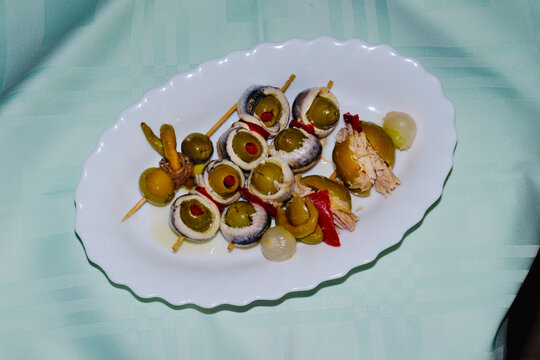 spanish banderillas, skewers with pickles, on a plate