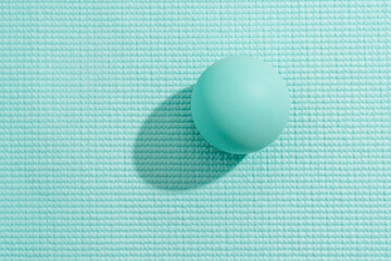 Blue Massage Ball on Textured Yoga Mat