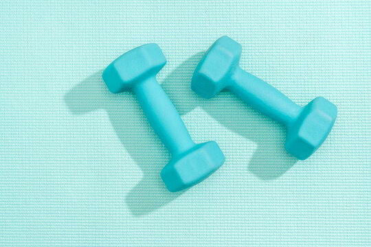 Pair of Blue Dumbbells on Yoga Mat