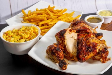 grill roasted chicken serve with french fries and salad in white plate