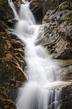Waterfall down a narrow gorge.