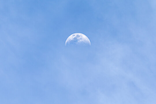 A half moon in daylight