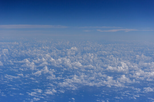 White clouds, blue sky flying into Fiji - Powered by Adobe