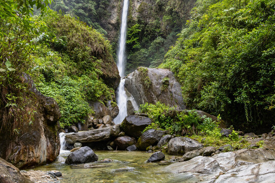 High waterfall in a jungle setting.
