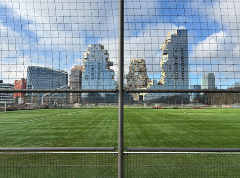 Fototapeta soccer field and modern buildings