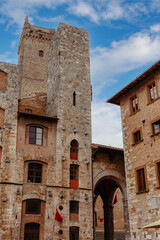 The historic charm of Piazza Duomo in San Gimignano, Tuscany, with its stunning medieval architecture and beautiful sky