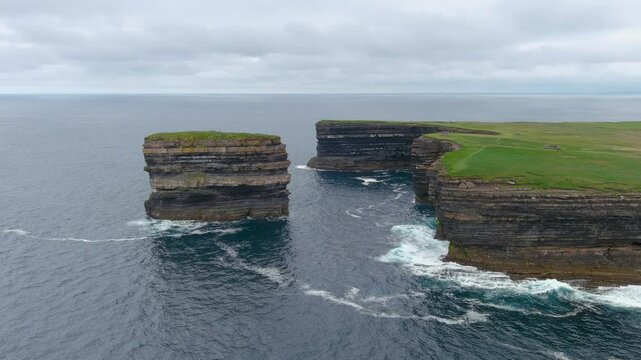Aerial view of stunning Downpatrick Head coastal landmark with iconic Dun Briste sea stack. Dramatic cliffs and waves. Raw beauty of Ireland's west coast. Wild Atlantic Way Signature Discovery Point.