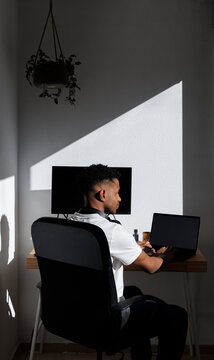 Back of Man at home office in sunlight