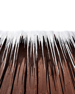 Icicles Hanging From Wooden Roof Boards in Bright Winter Light