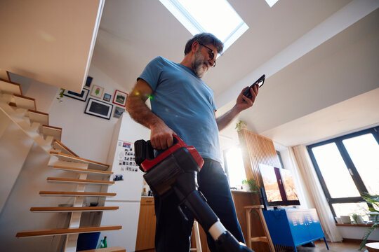 Man cleans his apartment