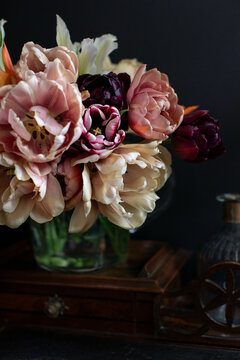 Multi coloured tulips in a bouquet in dramatic light
