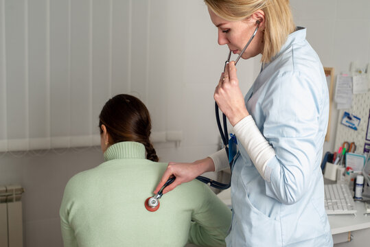 Doctor listening to patient with stetascope