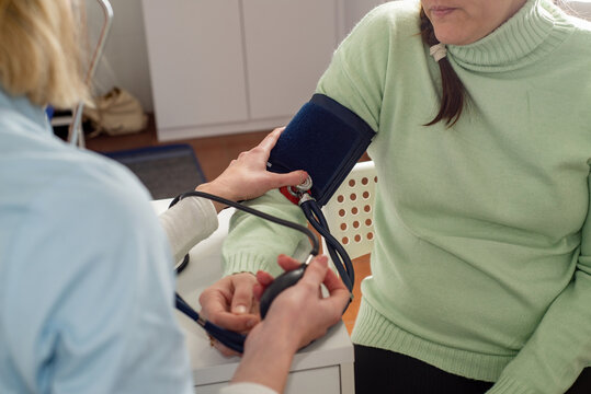 Doctor measures the patient's blood pressure