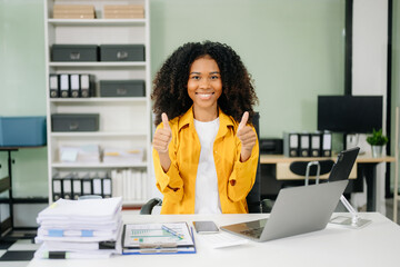 Young businesswoman working with working notepad, tablet and laptop documents talking on the...