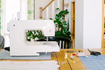 Sewing machine and accessories on the workbench.