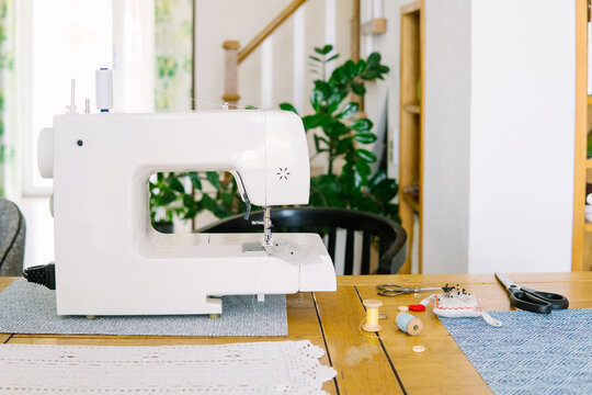 Sewing machine and accessories on the workbench.
