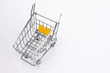 A shiny metal shopping cart on a white background