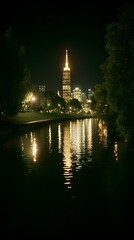 Night cityscape reflected in calm water. Skyscraper lights illuminate the dark scene.