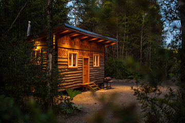 Cozy Wooden Cabin in Serene Forest Setting at Dusk