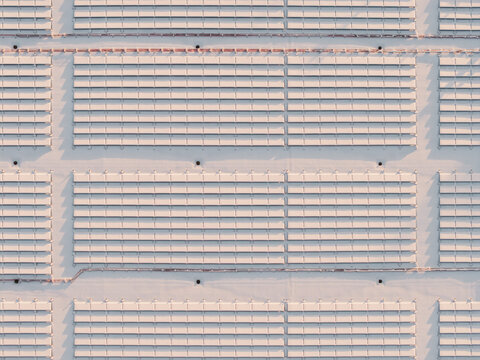 Aerial View of Snow-Covered Solar Panels on a Rooftop