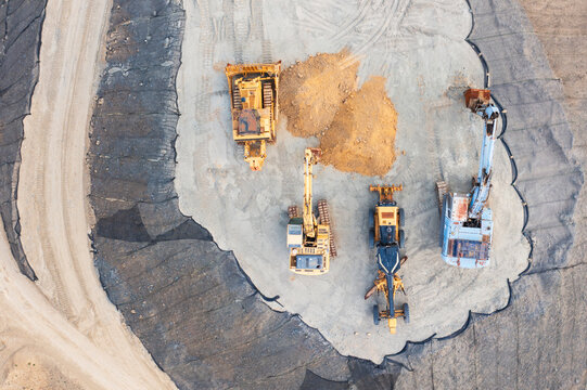 Construction Vehicles Leveling Earth at Construction Site