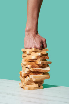 man smashing a stack o slices of bread