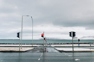 Coastal road intersection with red traffic light