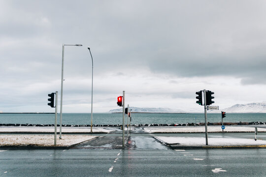 Coastal road intersection with red traffic light