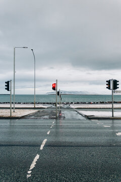 Empty coastal road with traffic lights and ocean view