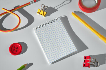 Brightly colored stationery items on a clean light desk surface.