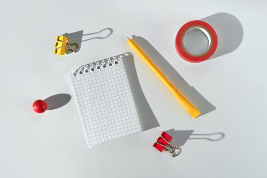 Brightly colored stationery items on a clean light desk surface.
