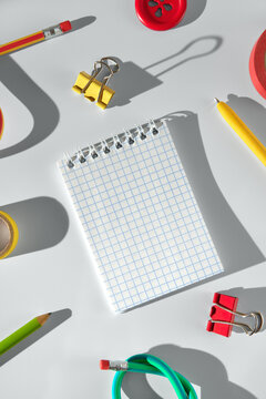 Brightly colored stationery items on a clean light desk surface.