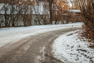 Rural road in Austria covered in ice and snow, emphasizing challenging winter driving conditions...
