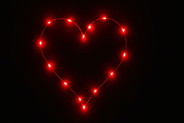 Red LED lights form a glowing heart against a black background. Bright, minimal, and perfect for romantic or Valentine's visuals.