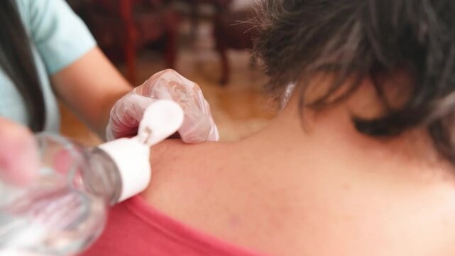 Cleaning and scanning of back muscles to begin dry needling treatment, use of gloves in physical rehabilitation procedure