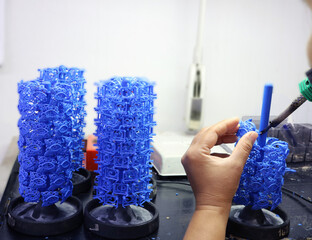 blue wax model setup, handcrafted jewelry mold design, Jewelry wax tree preparation for casting, artisan working on blue wax models in workshop