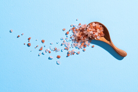 Himalayan Salt In Wooden Spoon On Light Blue Background